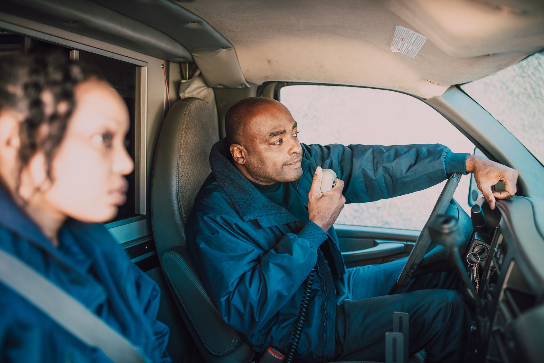 An EMS professional communicating by radio from an ambulance