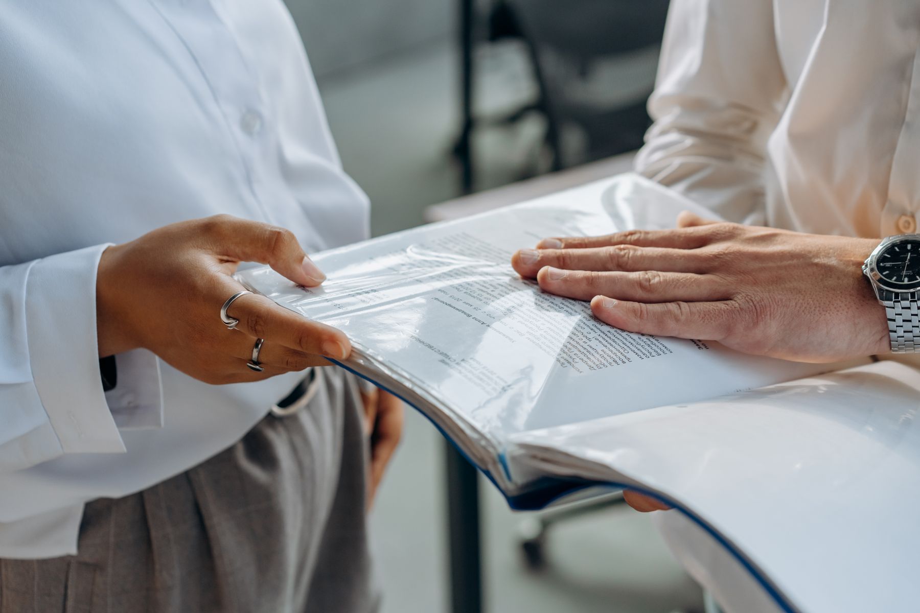 Two professionals reviewing a detailed document together